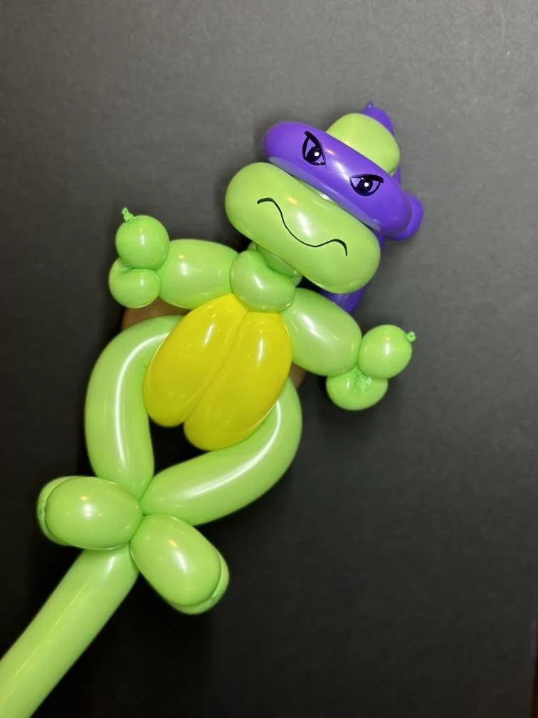 Handmade green and purple turtle balloon sculpture